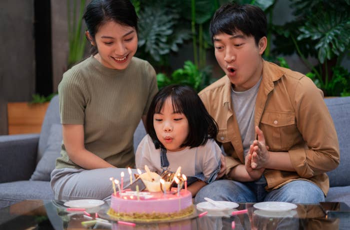 Young Asian couple celebrates their daughter&#x27;s birthday
