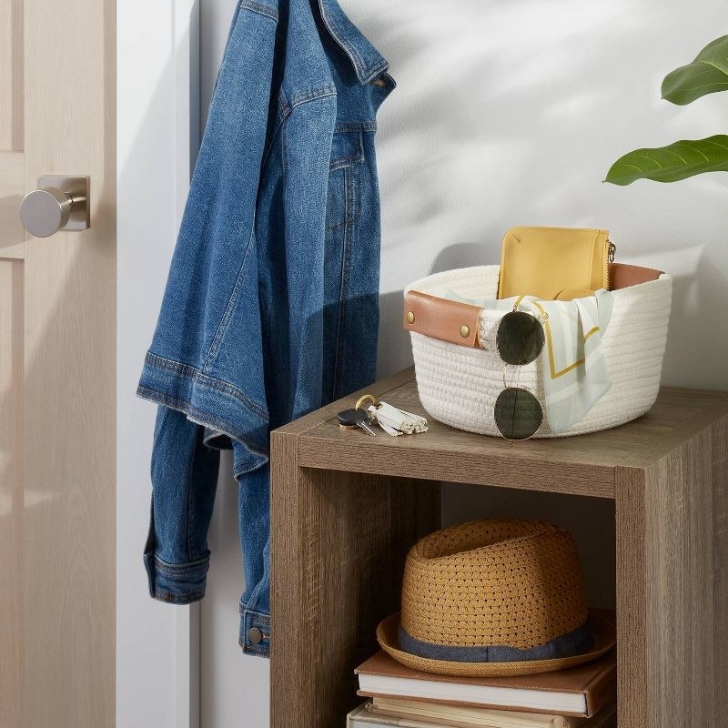 the white rope bin in a styled entryway setting
