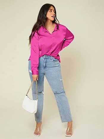 same model in a pink satin shirt