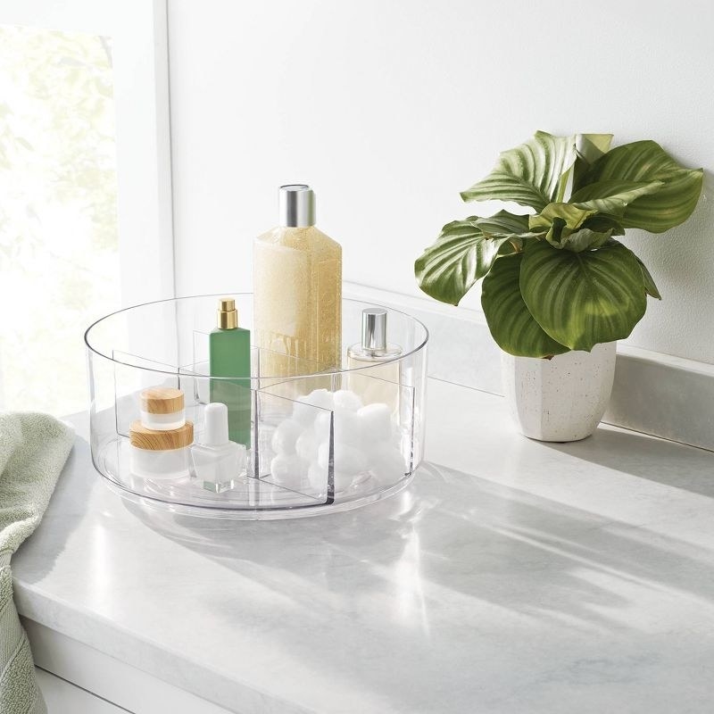 the clear organizer with products on a decorated counter space