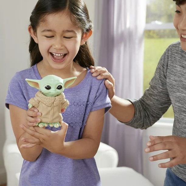 Two kids playing with Yoda Bop It