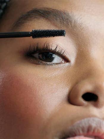model applying mascara to their lashes