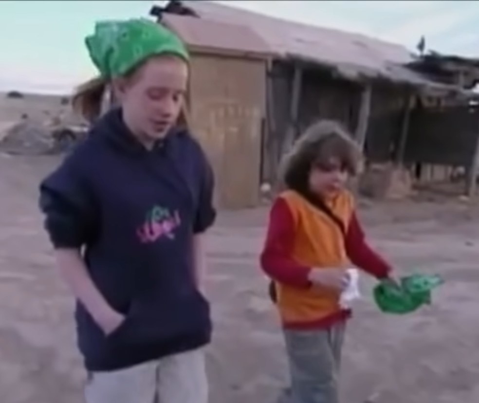 Two of the contestants in Kid Nation walk across the town