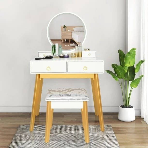 The vanity in the white color with gold accents