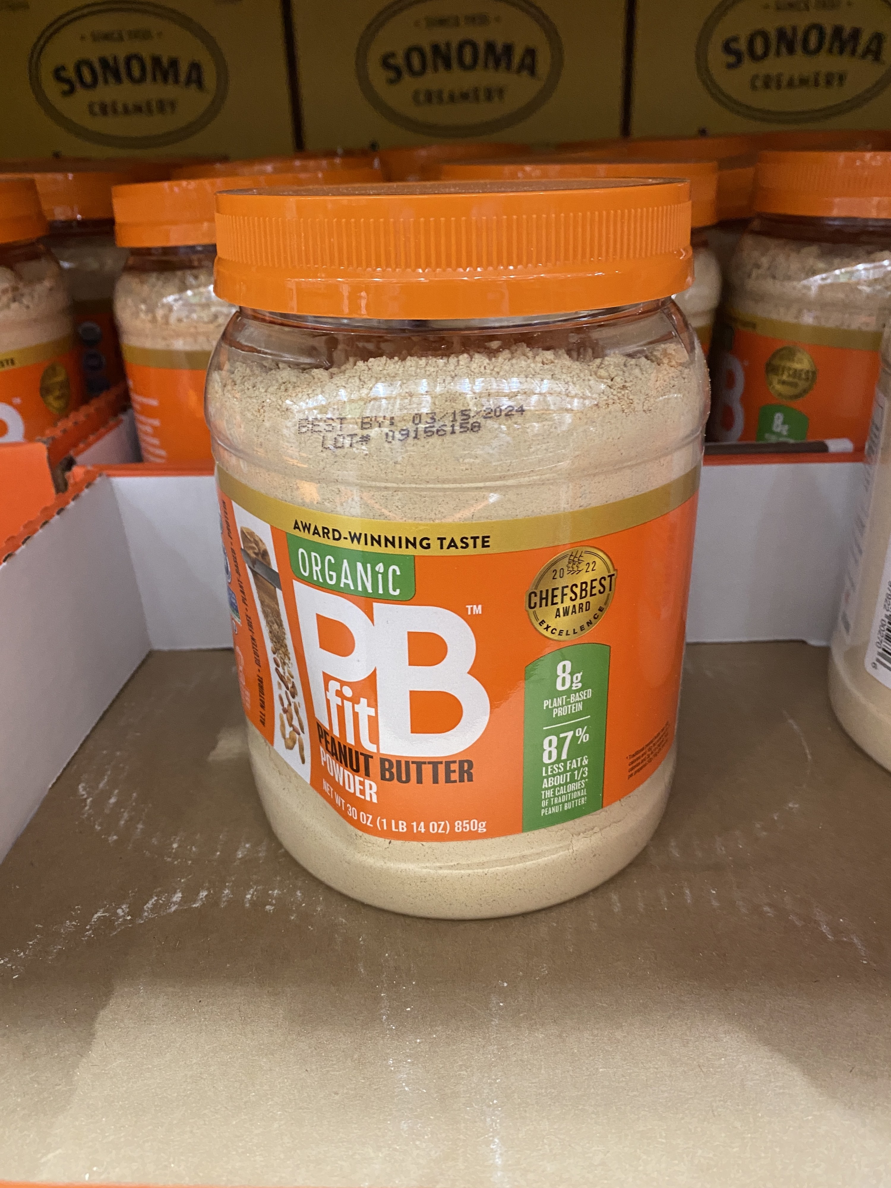 jar of peanut butter powder in cardboard bin