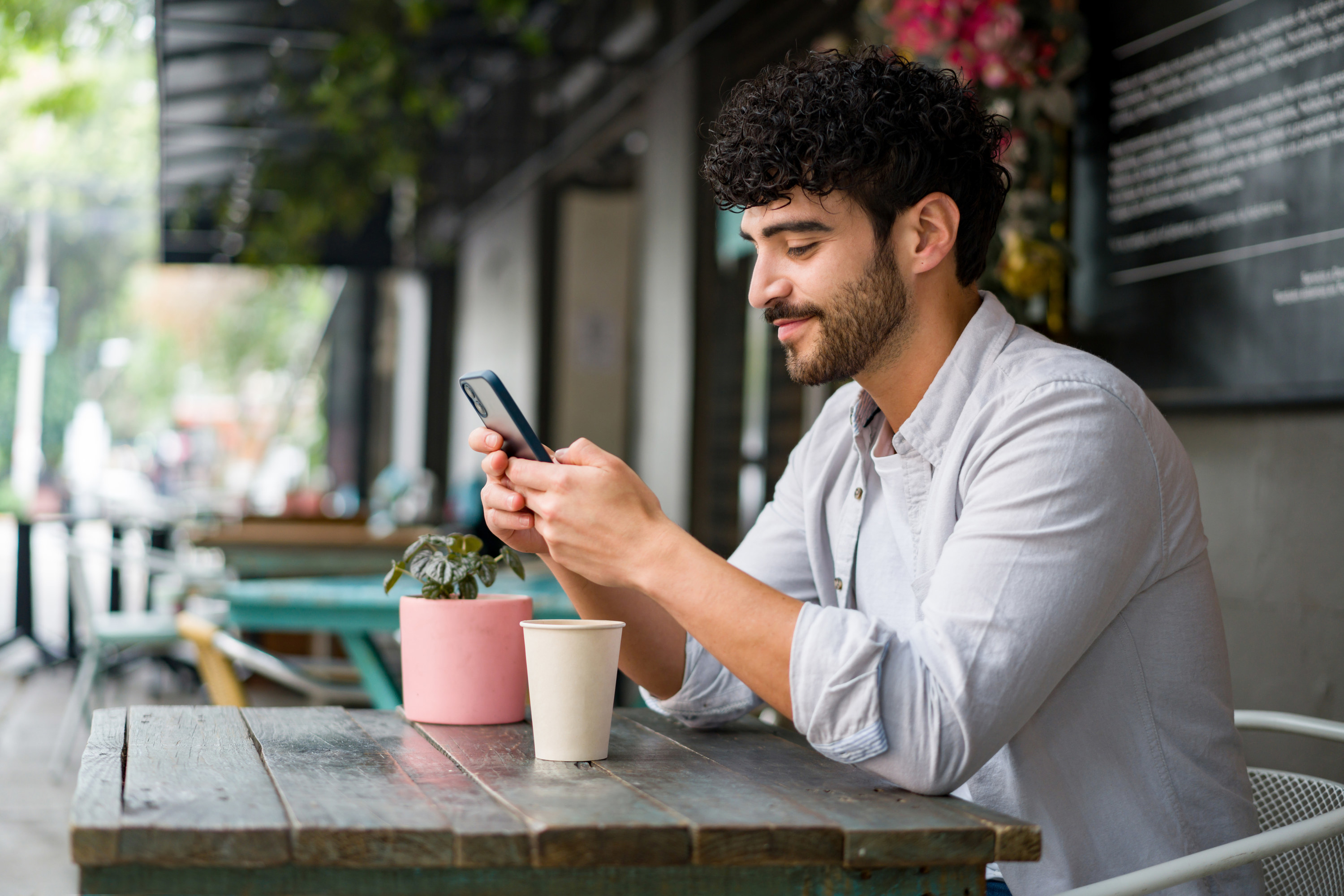 A person using an app at a restaurant outdoors