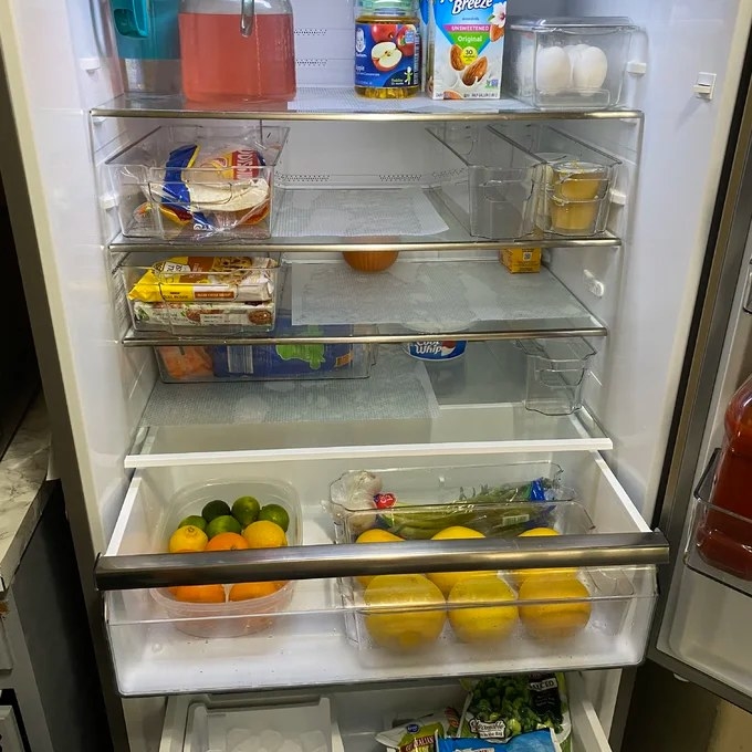 Reviewer&#x27;s photo of a fridge organized using the fridge bins