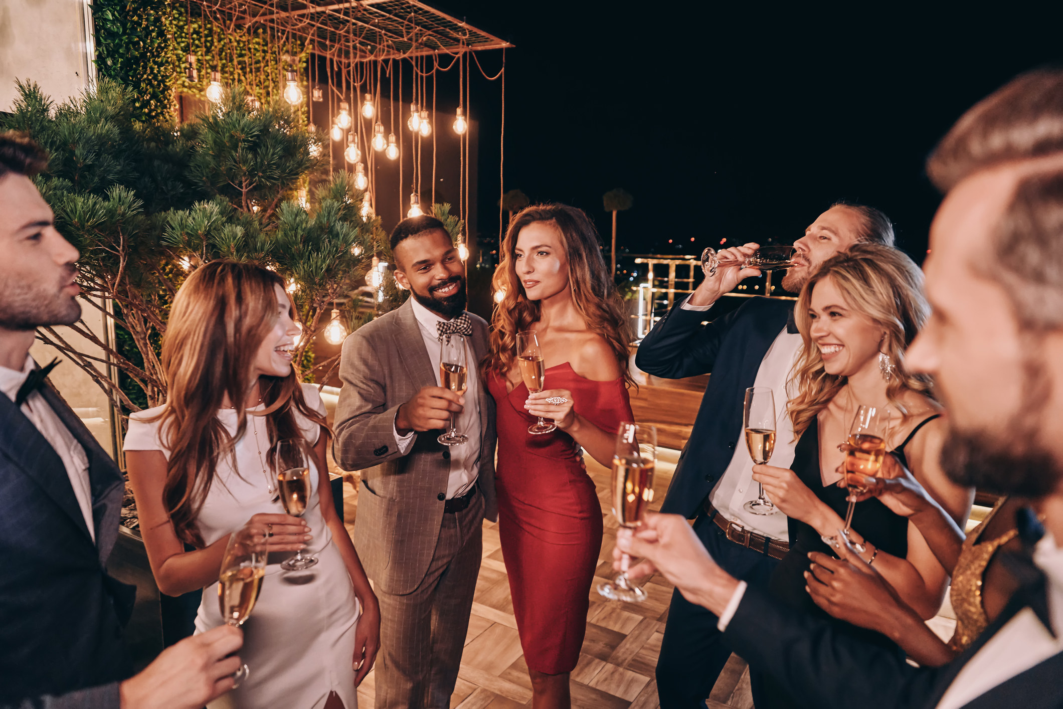 People at a party holding glasses of champagne
