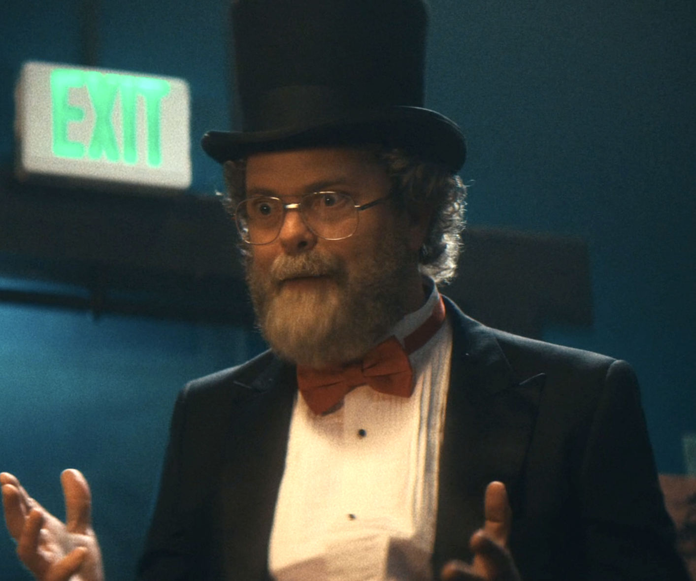 closeup of Rainn wearing a top hat and wired glasses