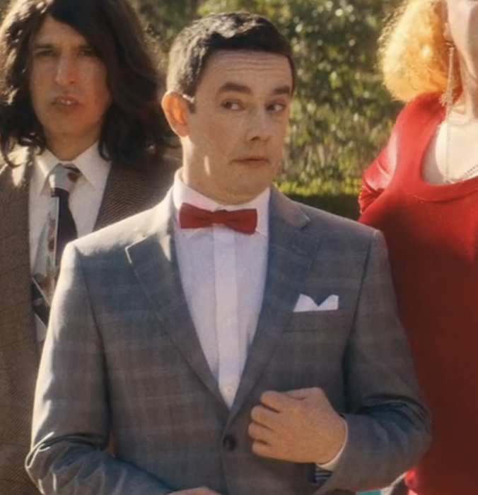 closeup of Jorma in character wearing a suit and bowtie