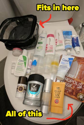 A bunch of reviewer's products laid on a toilet with the black bag next to it 