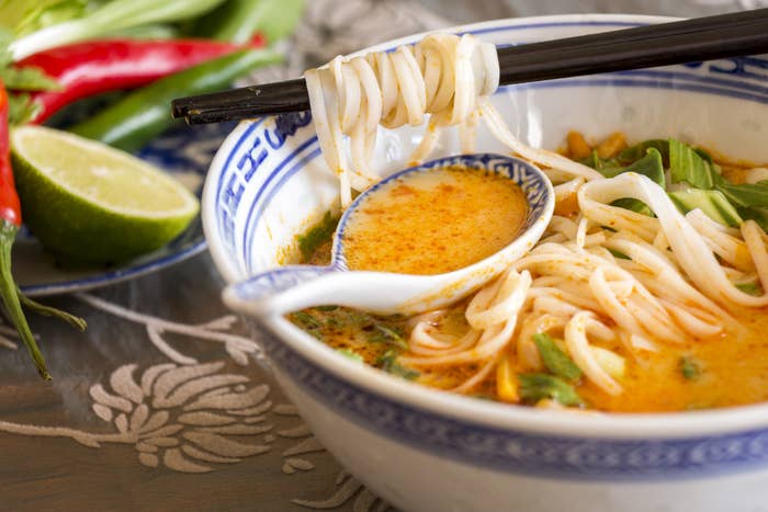 Bowl of spicy Asian soup with noodles.