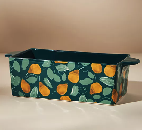 a dark green loaf pan with pears and holly leaves on it