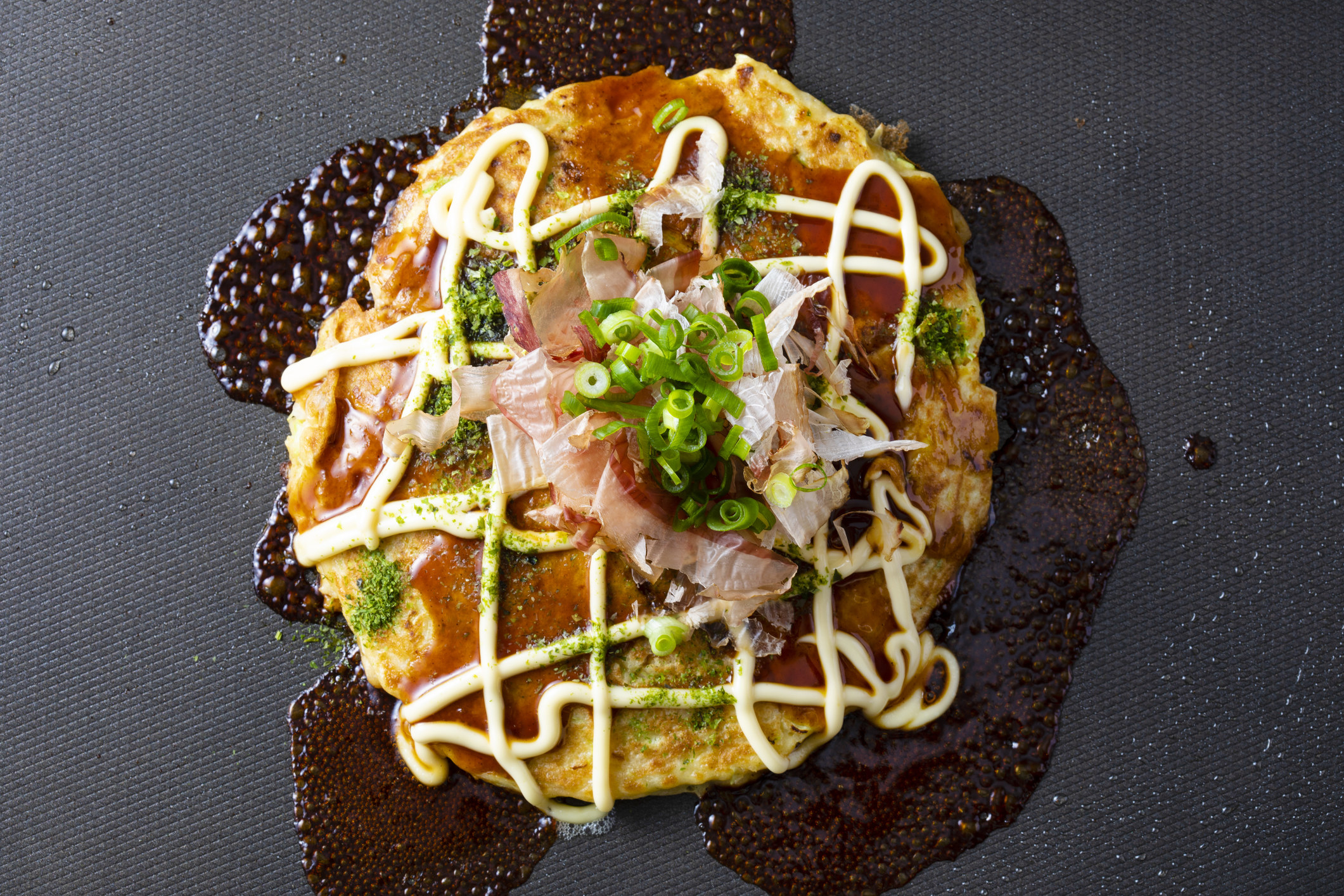 Japanese cabbage pancake drizzled with mayonnaise