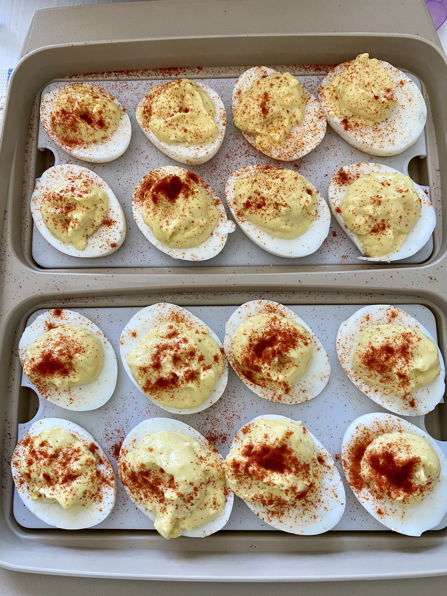 Deviled eggs topped with paprika.