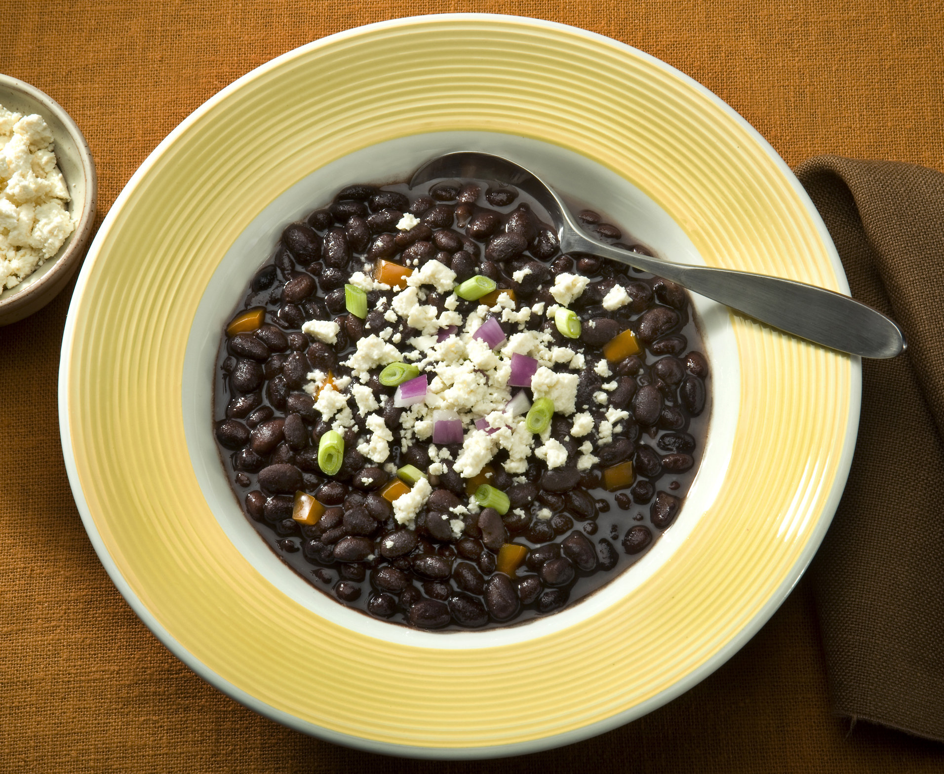 Black bean stew topped with cheese.