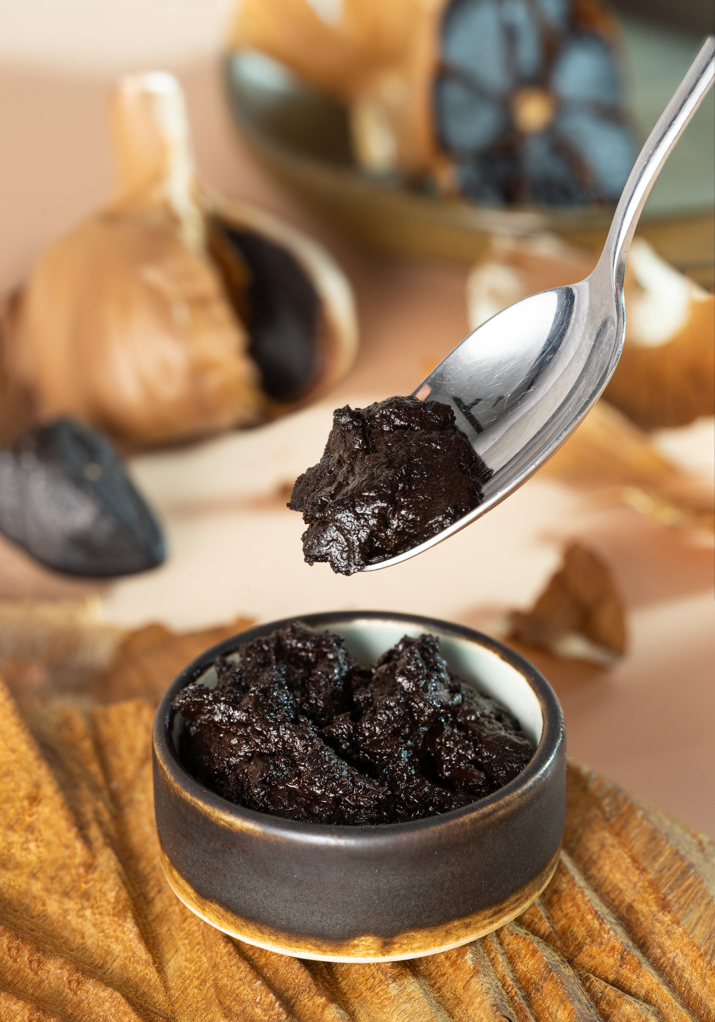 Spoon with black garlic paste.