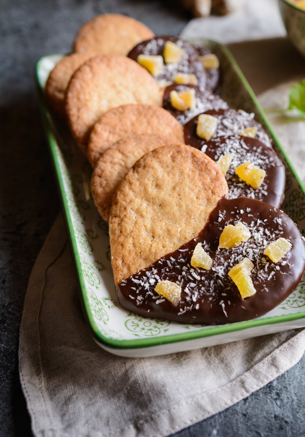 Biscuits decorated with chocolate and pieces of candied ginger.