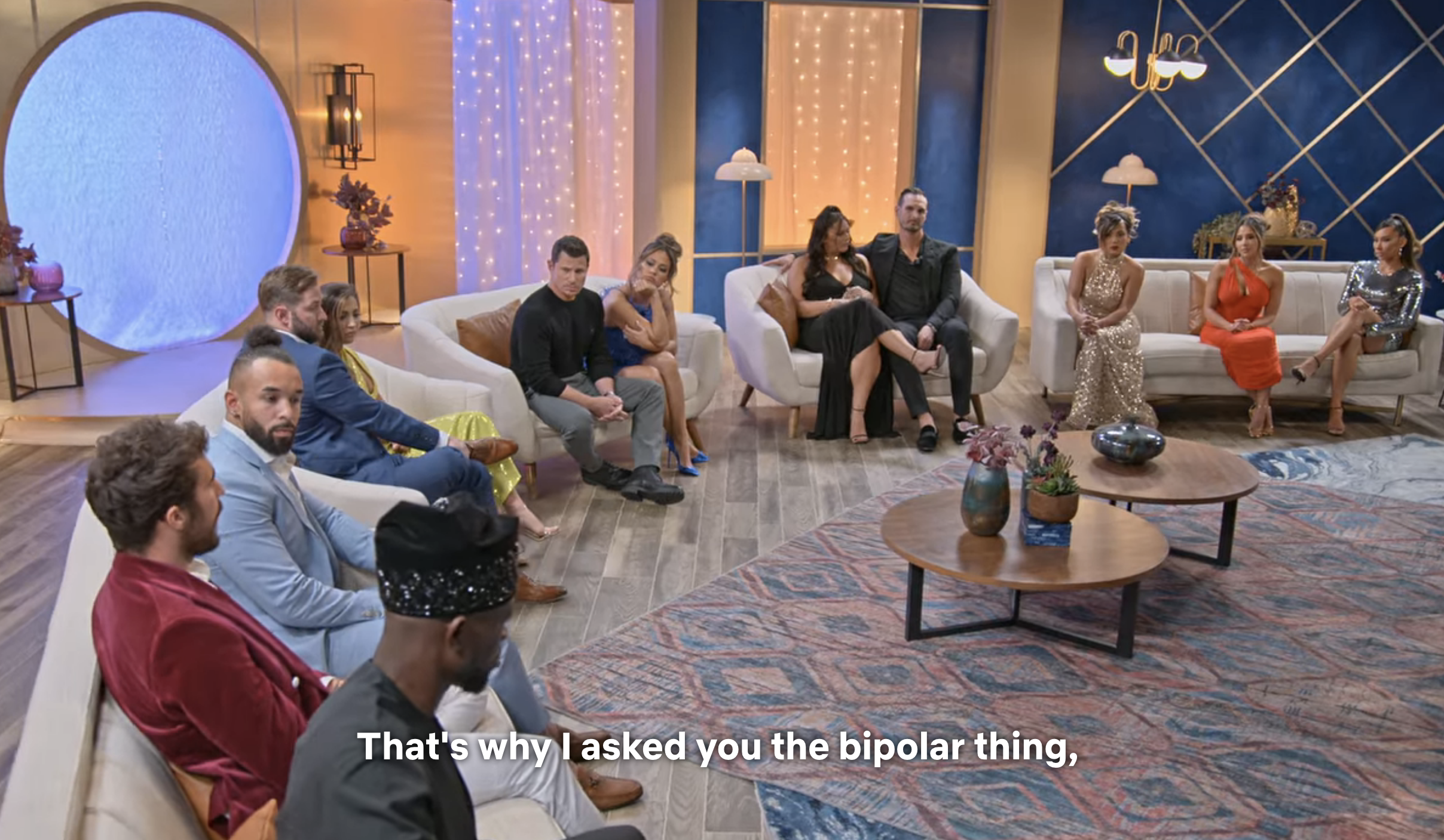 The cast sitting in the semicircle with the text &quot;That&#x27;s why I asked you the bipolar thing&quot;