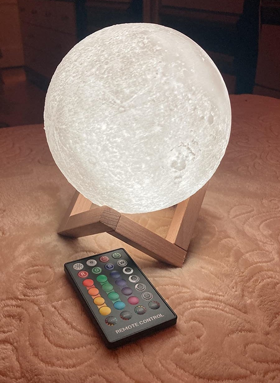 the moon-shaped light on a wooden stand