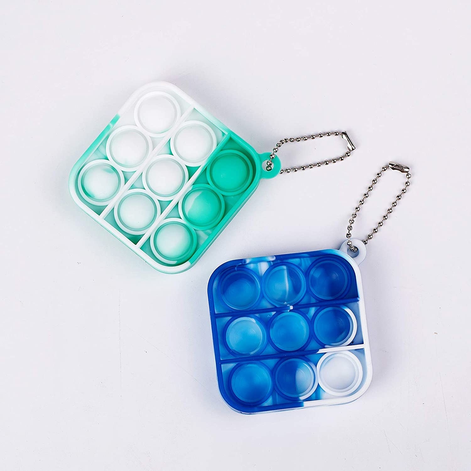two square bubble fidget keychains beside each other