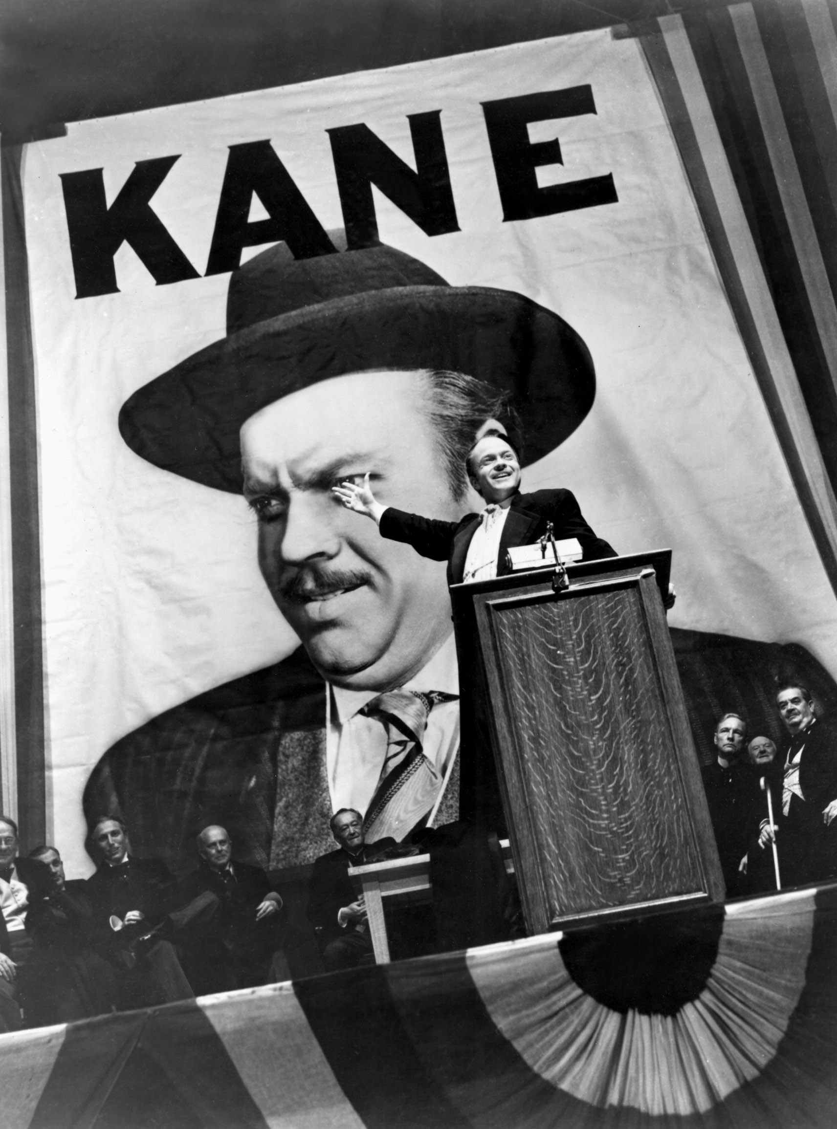 Scene from Citizen Kane showing a huge poster of Charles Foster Kane