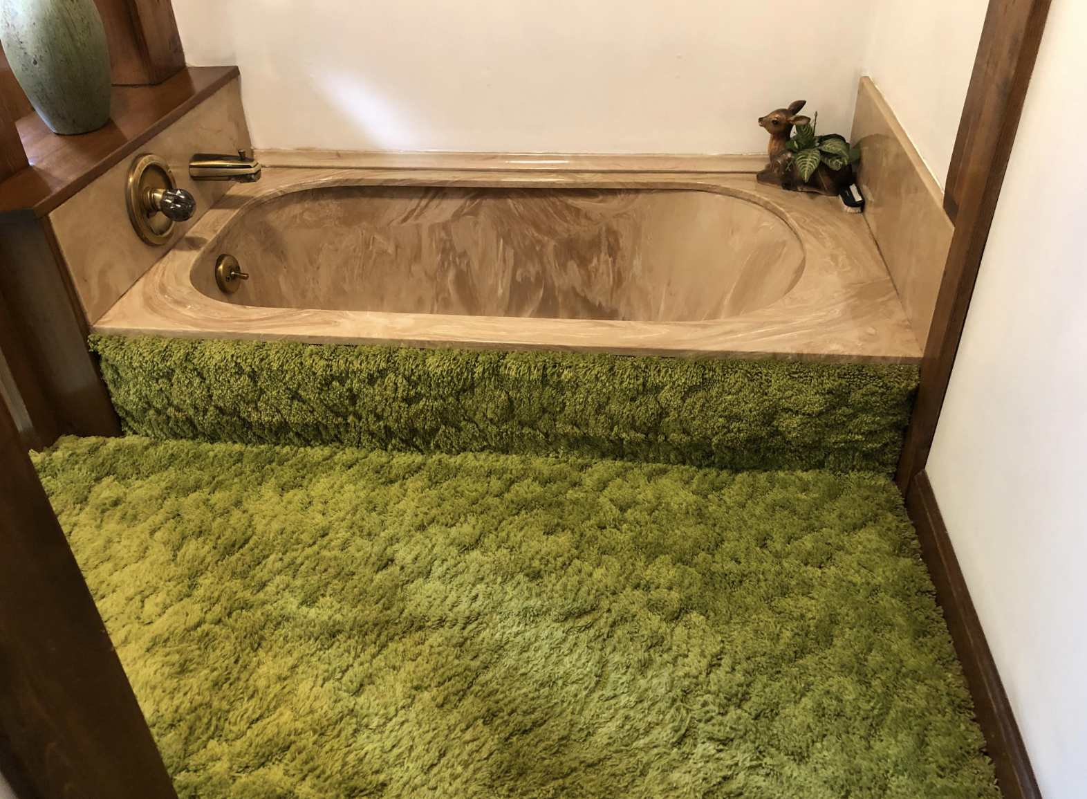 Green carpet in a bathroom