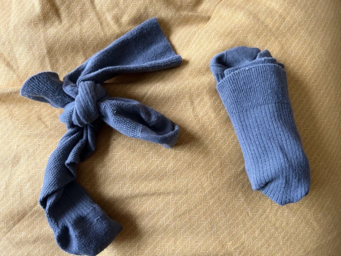 pair of socks knotted together next to a normally folded pair of socks