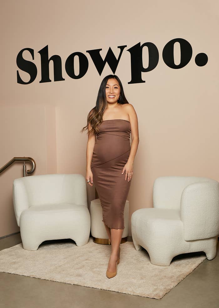 Jane Lu stands in front of a wall that reads, &quot;Showpo&quot;