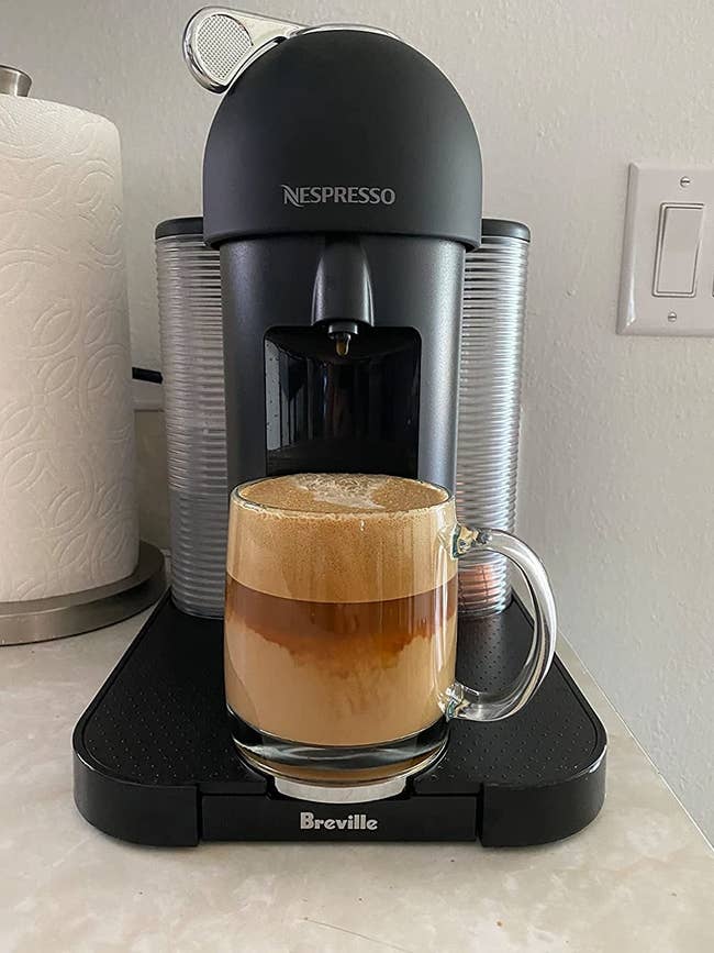 reviewer's machine with a cup of coffee brewed 