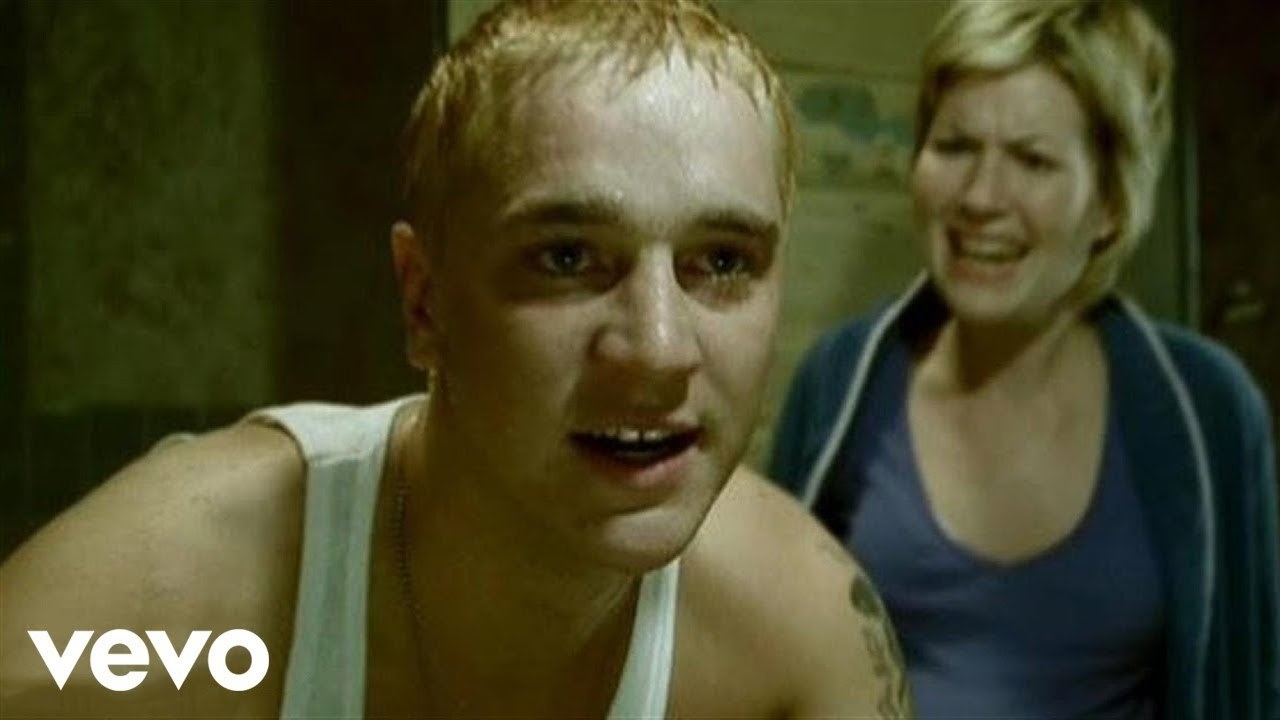 Devon Sawa dressed as Eminem, looking in the mirror while his girlfriend yells at him