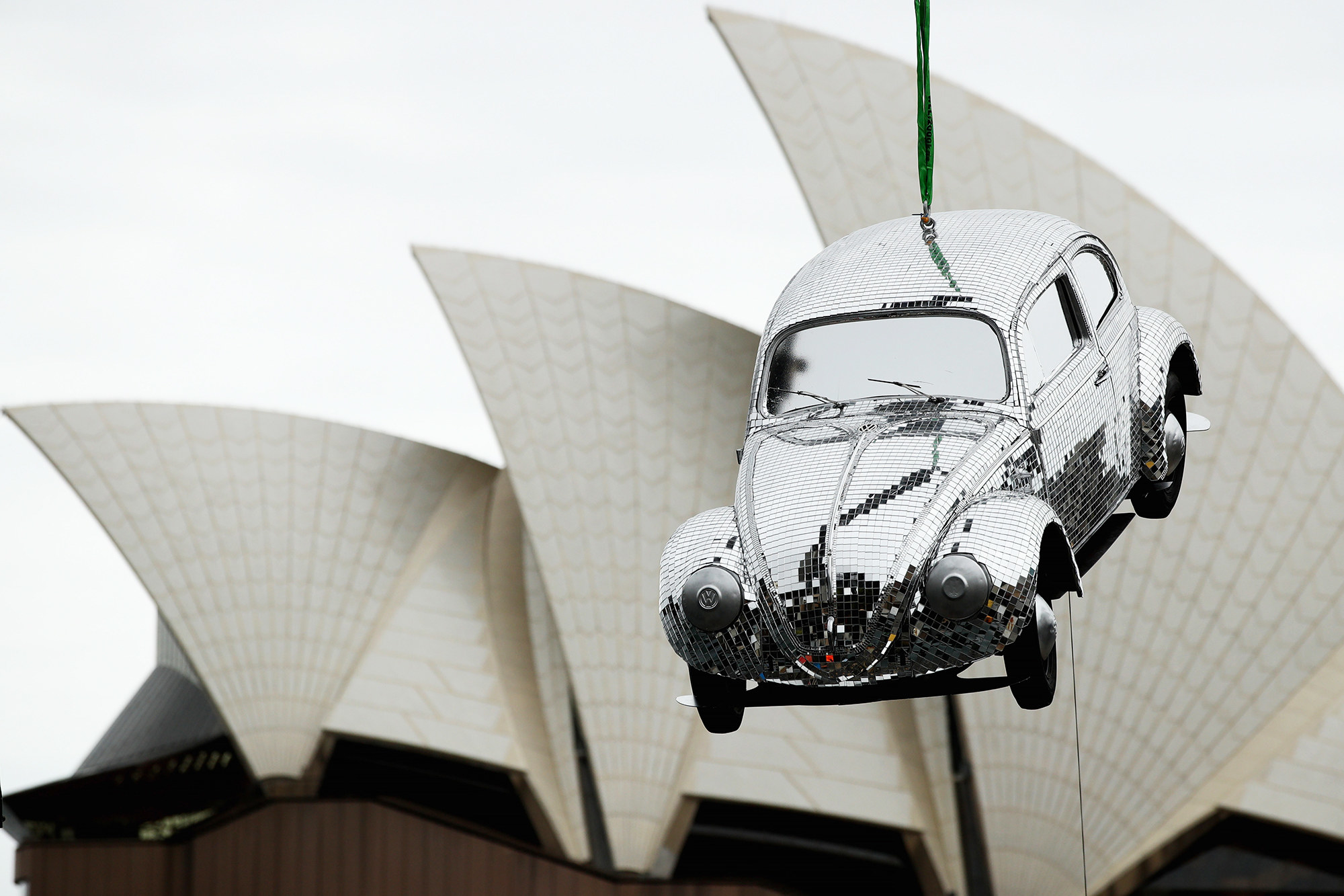 Sydney opera house in the background; floating sparkly Volkswagen in the foreground