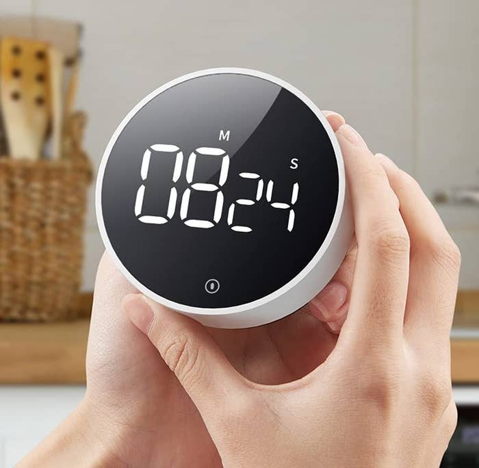 A person holding the timer