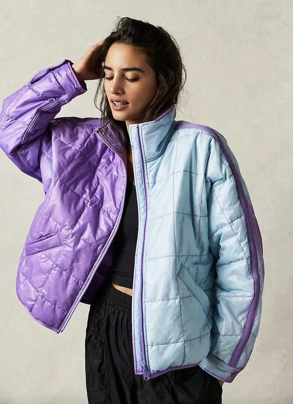 a person wearing the colour-changing puffer coat; half of it is one colour, the other half is another colour