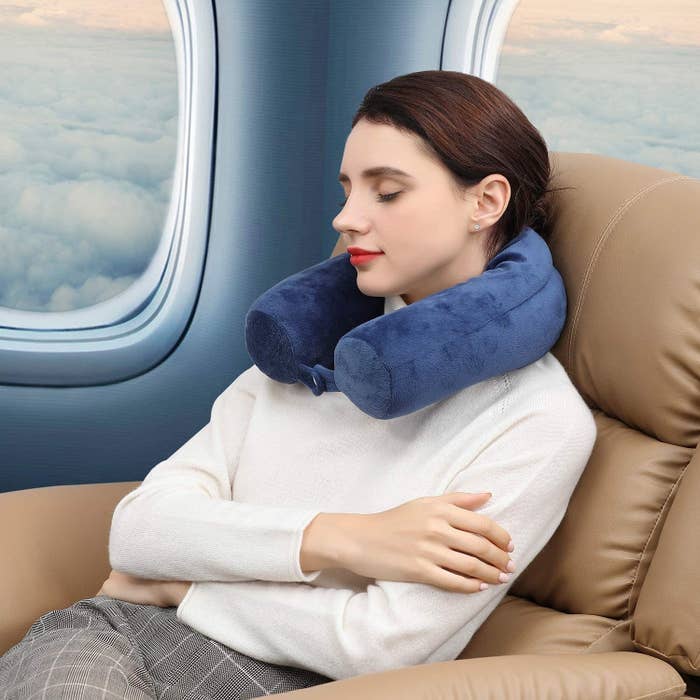A picture of a person wearing the travel pillow around their neck