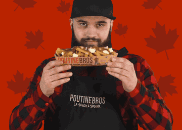 man smelling poutine and winking