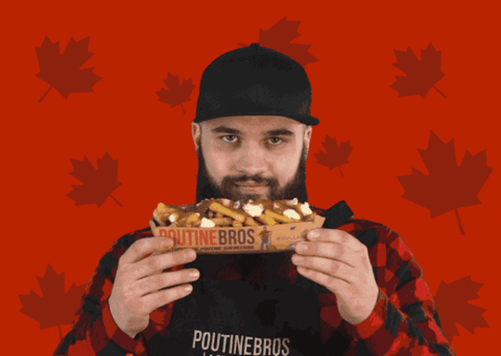 man smelling poutine and winking
