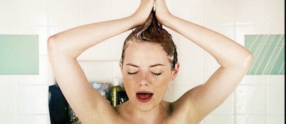 a gif of a girl washing her hair in the shower