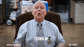 a gif of a character from brooklyn nine nine saying crown me