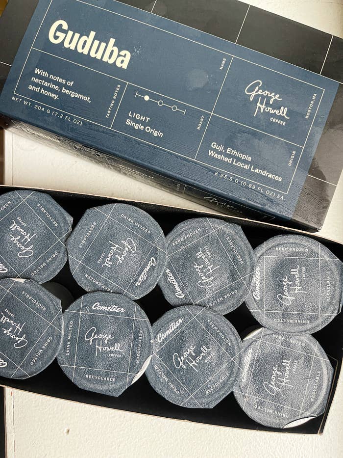 package of eight coffee capsules in a small blue box