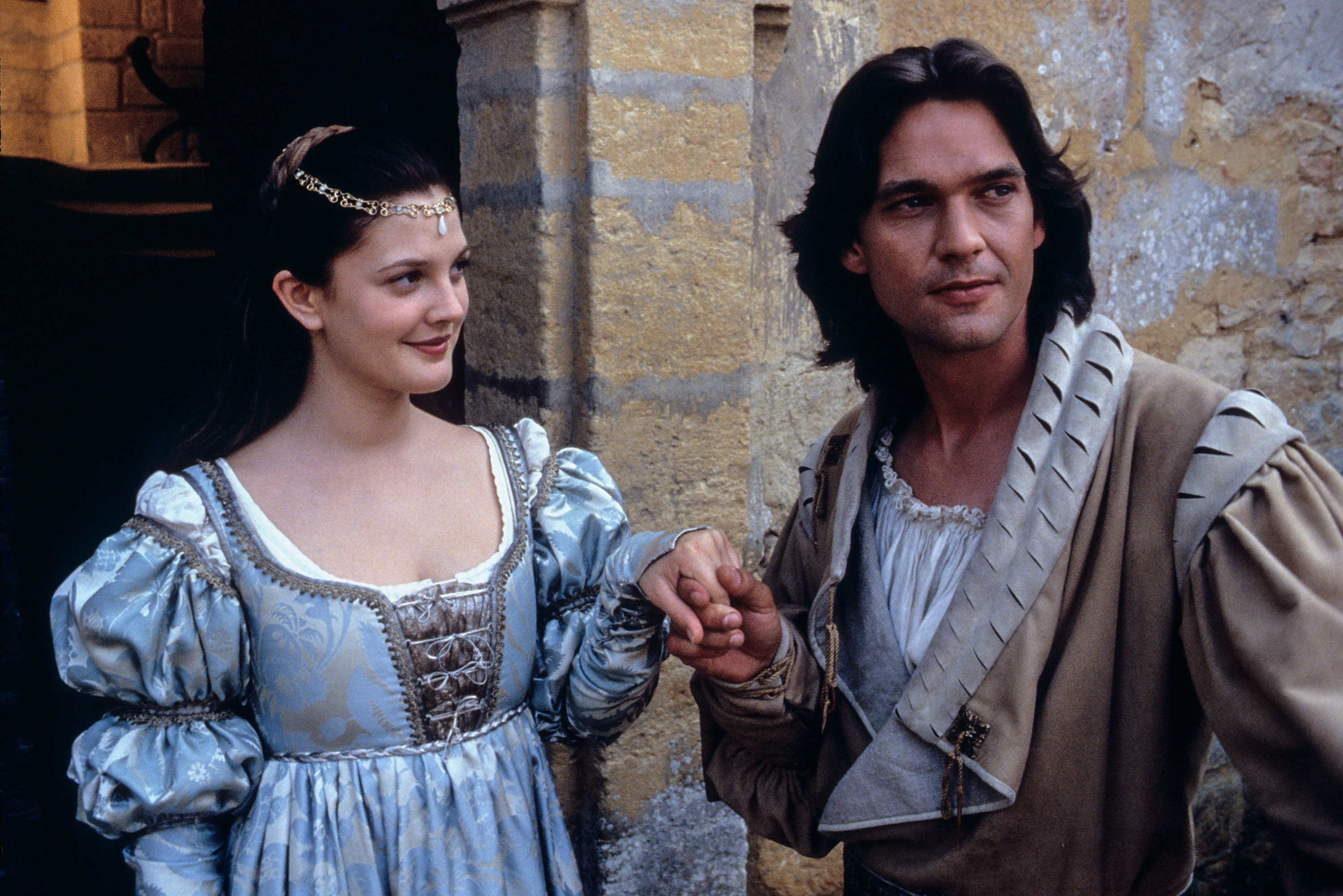 Drew Barrymore and Dougray Scott holding hands.