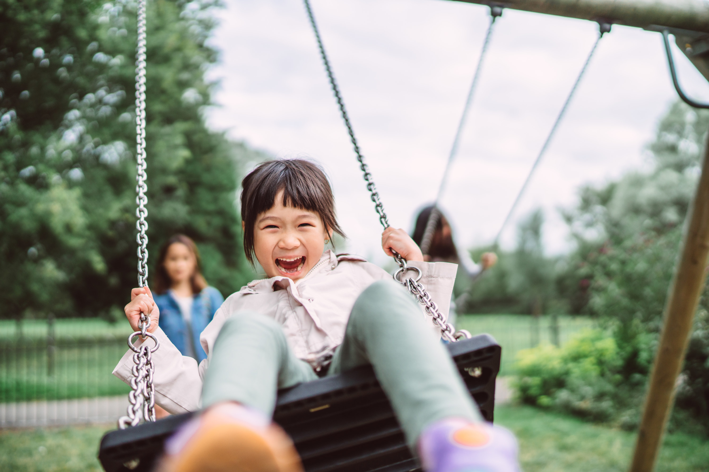 a kid swinging on the swings