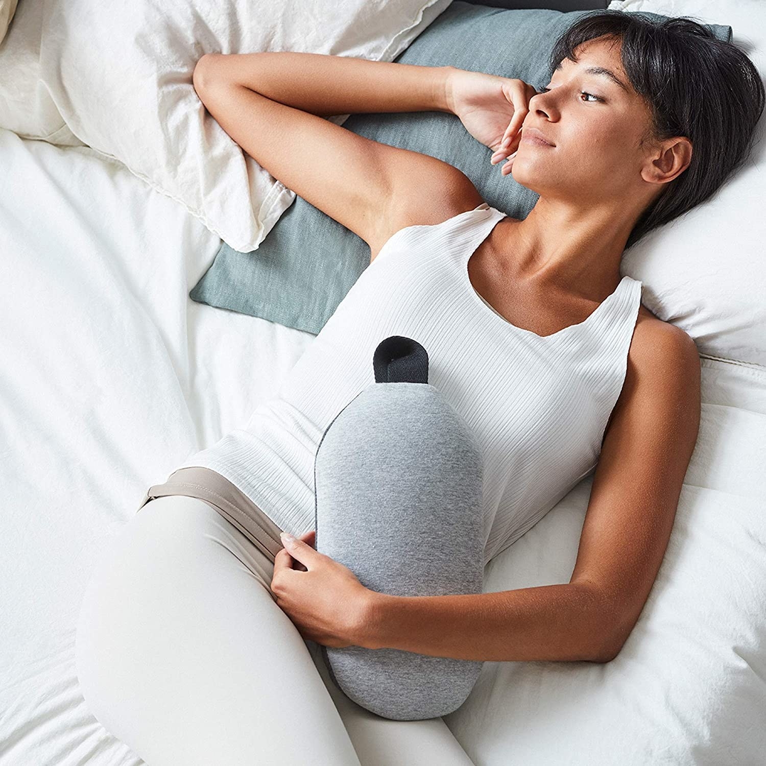 a person lying in bed and cuddling with the ostrichpillow