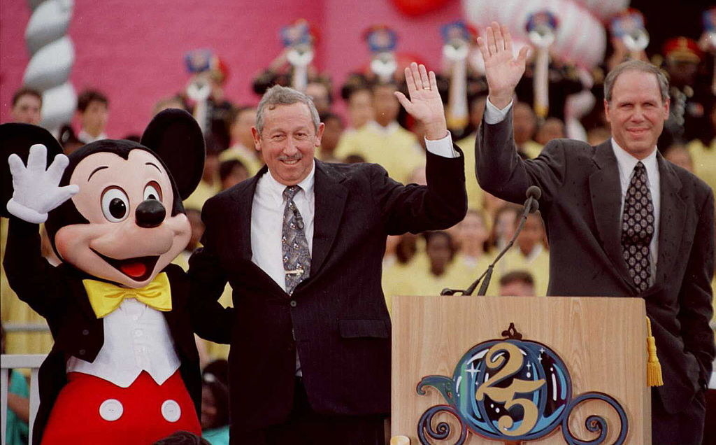 Roy Disney Jr and Michael Eisner waving with Mickey Mouse