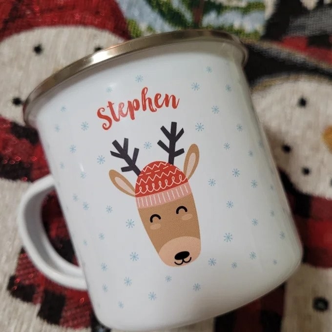 White mug with reindeer on it that says Stephen