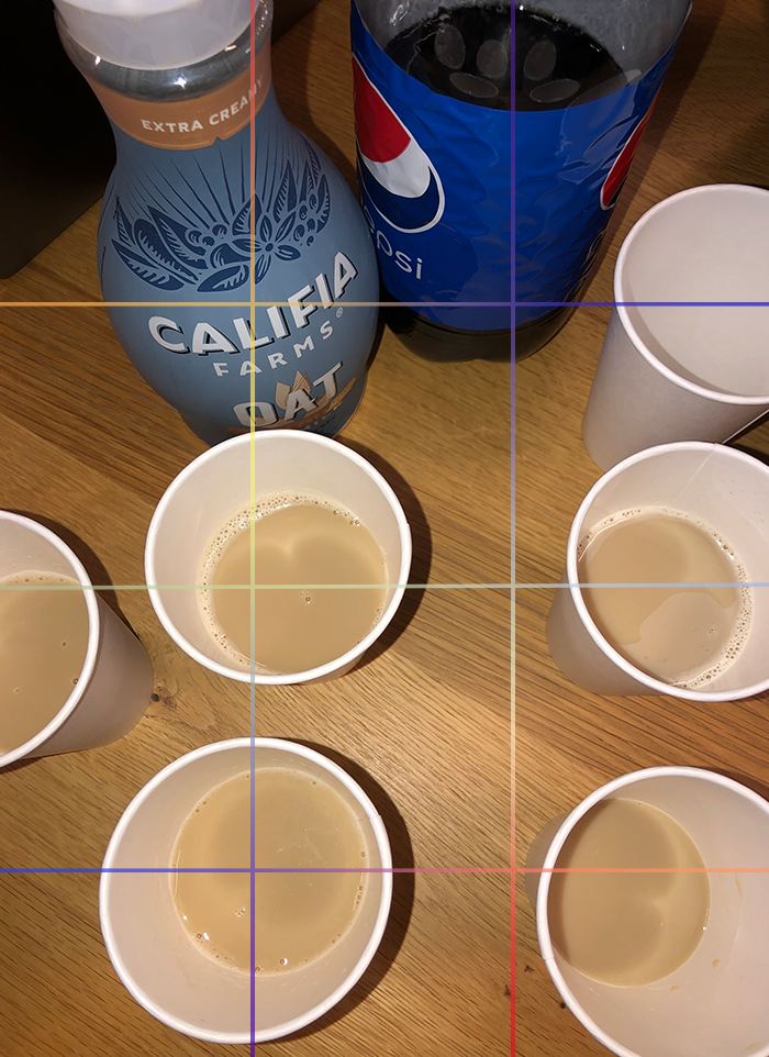 Cups of beige liquid on a table