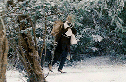 Amanda trekking her suitcase through the snow