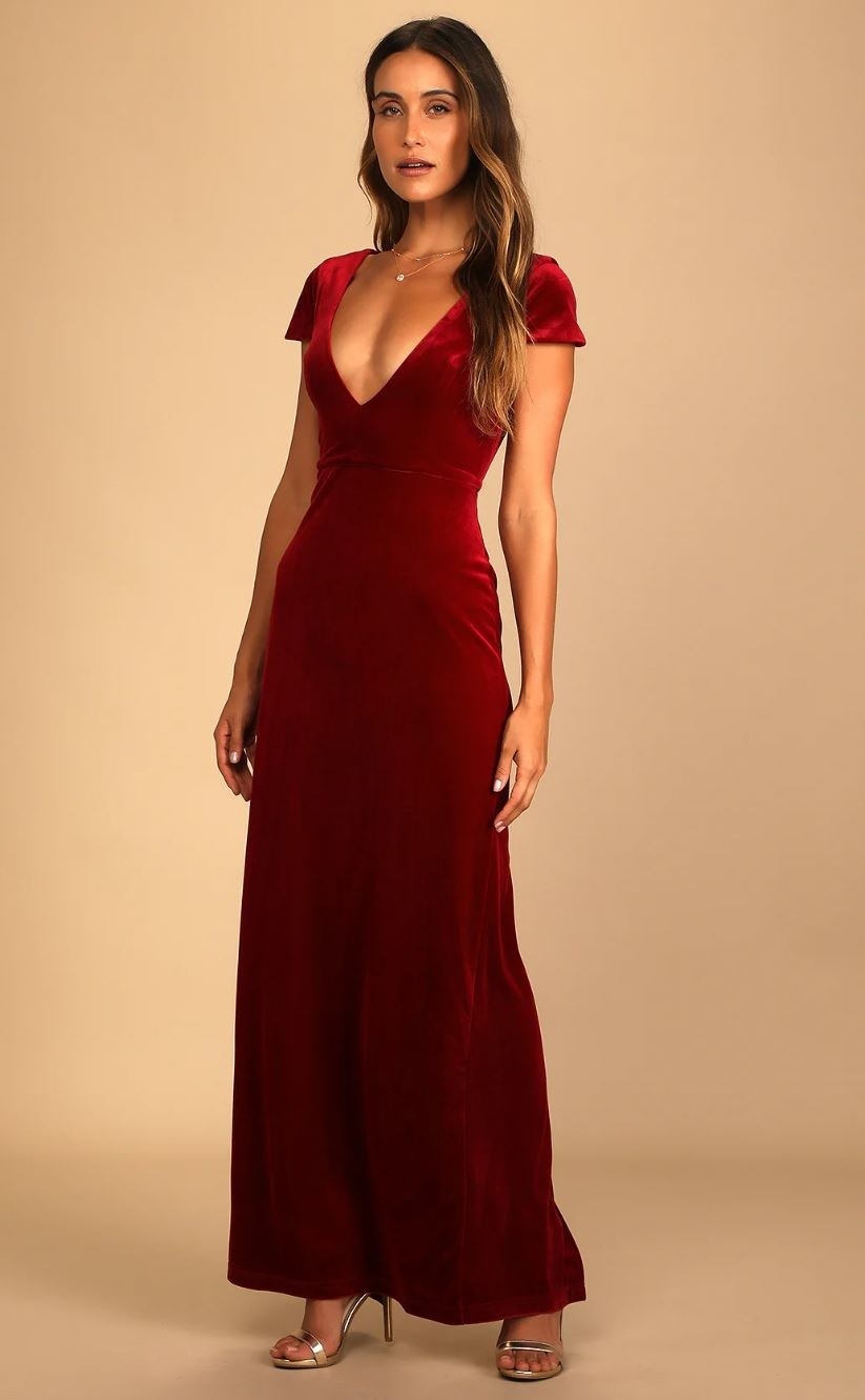 model wearing red velvet cap sleeve gown