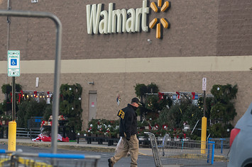An FBI agent is seen outside a Walmart store