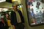 Mehran Karimi Nasseri pictured next to a poster of The Terminal, the movie that he inspired.